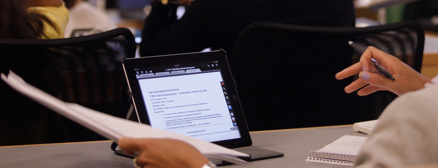 tablet in front of a student in a classroom